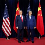Donald Trump and Xi Jinping posing for a photo in front of their respective national flags.