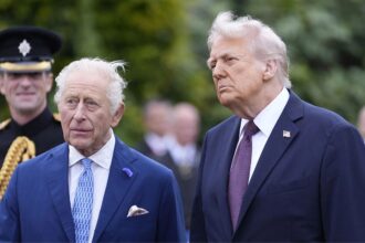 King Charles III and Donald Trump posing together for a photo.