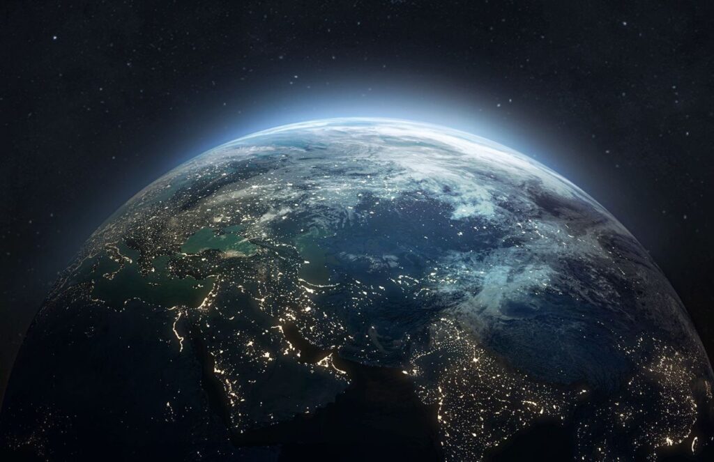 Earth seen from space, showing some continents and the lights of its cities.