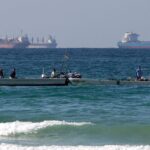 Several vessels in the open sea waiting to be received at the ports.
