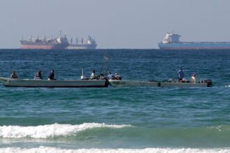 Several vessels in the open sea waiting to be received at the ports.