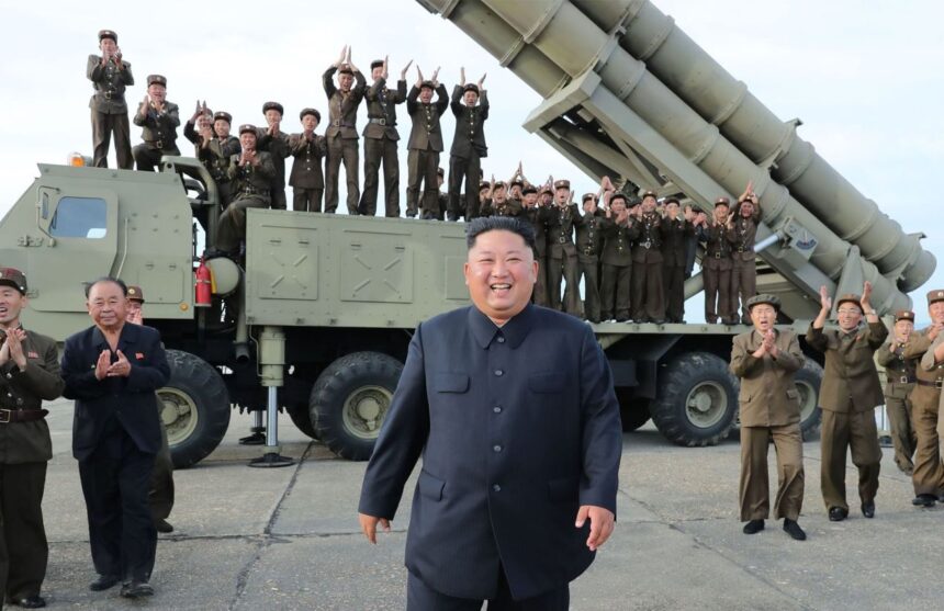 A panoramic image of the leader of North Korea with several soldiers behind him, riding in a bomber vehicle.
