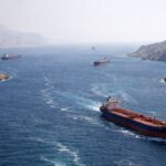 Several cargo ships transporting goods through the Strait of Hormuz.