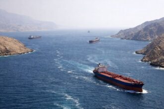 Several cargo ships transporting goods through the Strait of Hormuz.