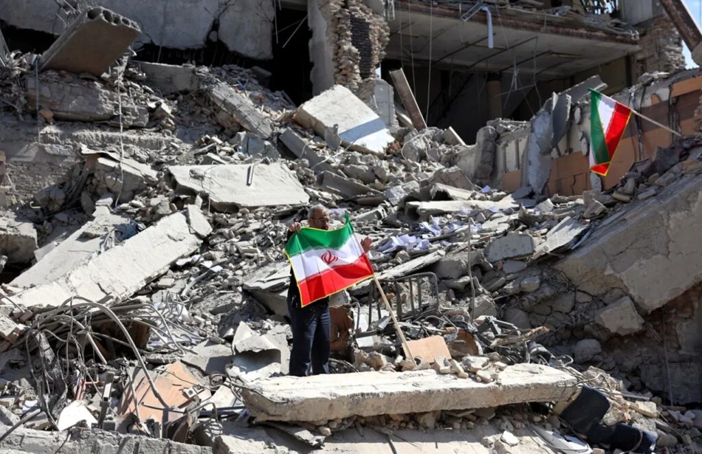 Historic truce the United States and Iran reopen the Strait of Hormuz and ease global tensions A scene of total destruction with some Iran flags being raised by people