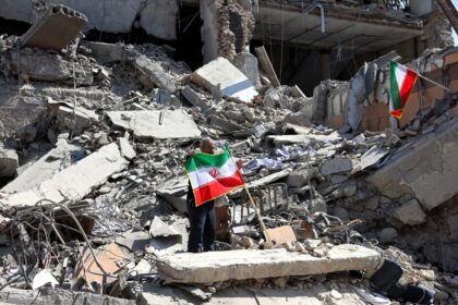 Historic truce the United States and Iran reopen the Strait of Hormuz and ease global tensions A scene of total destruction with some Iran flags being raised by people