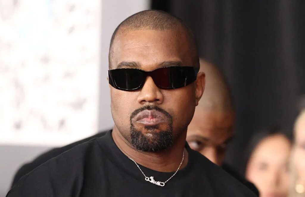 The American singer and songwriter walking down the street while wearing dark sunglasses