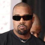 The American singer and songwriter walking down the street while wearing dark sunglasses