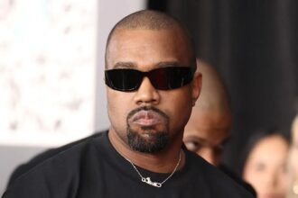 The American singer and songwriter walking down the street while wearing dark sunglasses