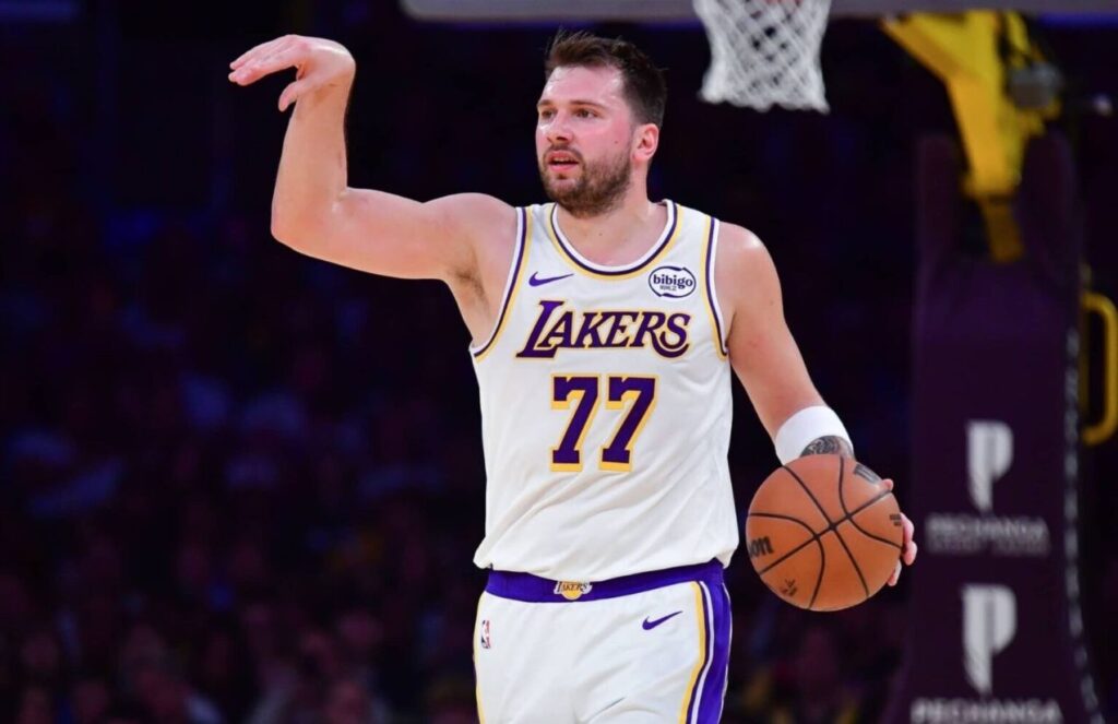 Luka Dončić directing his teammates during a game to set up a play.