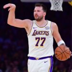 Luka Dončić directing his teammates during a game to set up a play.
