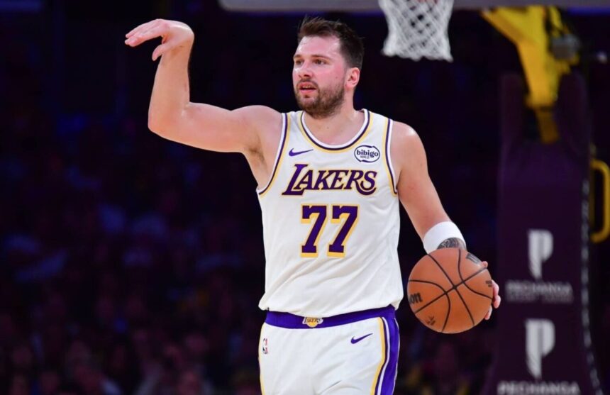 Luka Dončić directing his teammates during a game to set up a play.