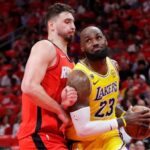 LeBron James battling with Alperen Sengun to drive to the basket and score.