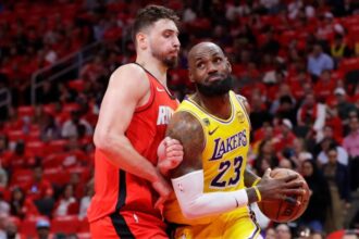 LeBron James battling with Alperen Sengun to drive to the basket and score.