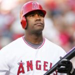 Anderson holding his bat while walking toward the batter’s box.