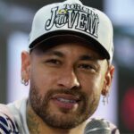 Neymar sitting in style at a press conference