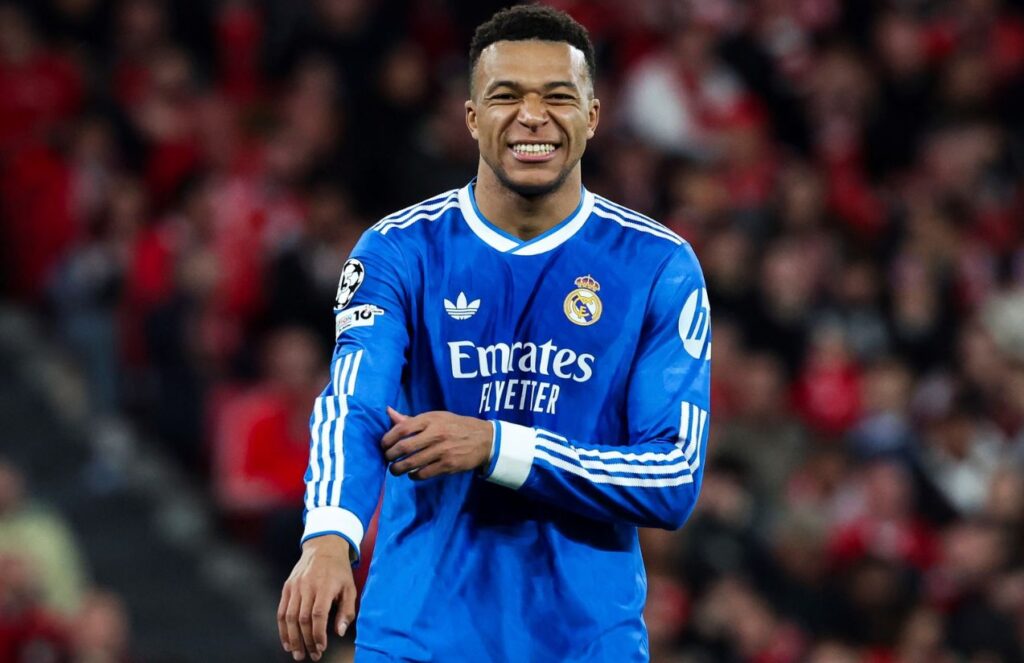 The outstanding French striker wearing the blue Real Madrid uniform with a slightly painful expression on his face.