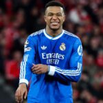 The outstanding French striker wearing the blue Real Madrid uniform with a slightly painful expression on his face.