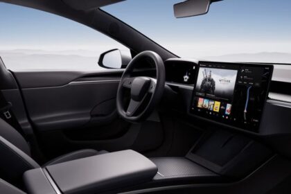 A Tesla car seen from the inside, showing its steering wheel and screen