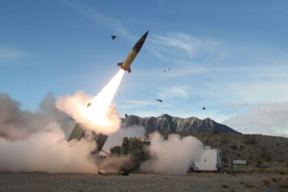 A Russian military vehicle carrying several missiles while one of them is being launched