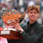 Jannik Sinner lifting his trophy after leaving Carlos Alcaraz as world No. 2 in the ATP rankings.