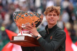 Jannik Sinner lifting his trophy after leaving Carlos Alcaraz as world No. 2 in the ATP rankings.