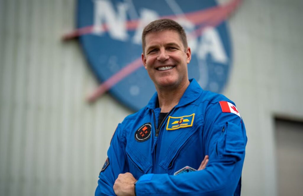 Shocking space account: Jeremy Hansen describes the most intense moment on the way to the Moon A photo of a space pilot smiling while wearing a spacesuit, with the NASA logo in the background