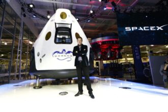 Elon standing in front of the nose of a SpaceX rocket