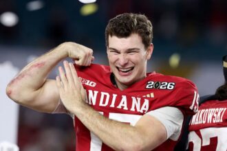 Fernando showing his strength to the crowd by flexing his arm muscles after winning a game.