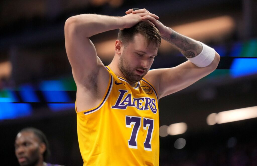 Luka Magic holding his head during a game after a tough decision