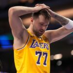 Luka Magic holding his head during a game after a tough decision