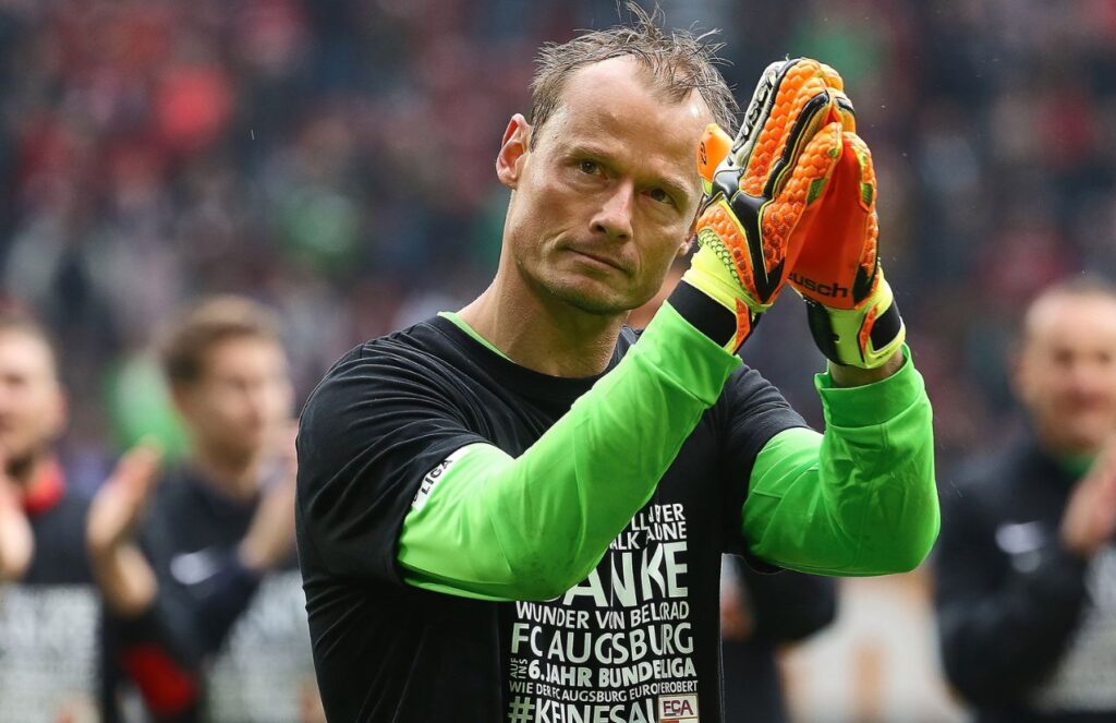 The legendary goalkeeper waving to the crowd after finishing a soccer match.