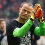 The legendary goalkeeper waving to the crowd after finishing a soccer match.