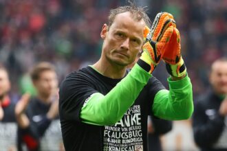 The legendary goalkeeper waving to the crowd after finishing a soccer match.