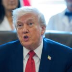 Donald Trump speaking with his supporters while sitting in his office