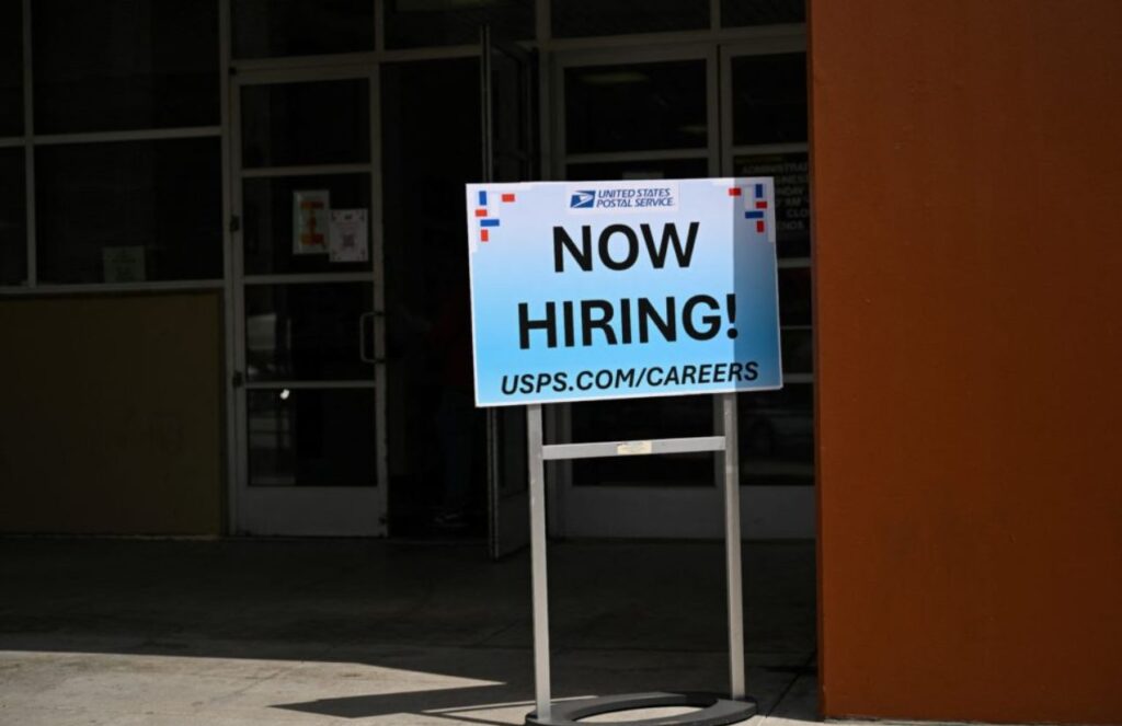 United States surprises with strong job growth and falling unemployment A blue sign that says a company is hiring