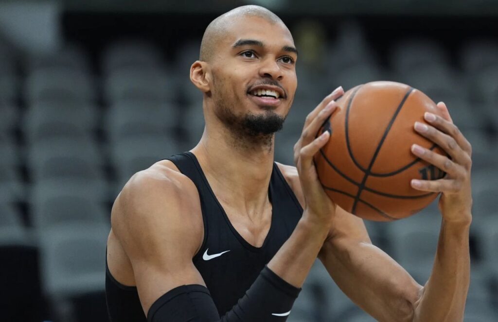 Victor about to take a shot during a training session with a shaved head.