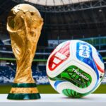 A FIFA World Cup trophy next to the ball that will be used throughout the entire tournament.