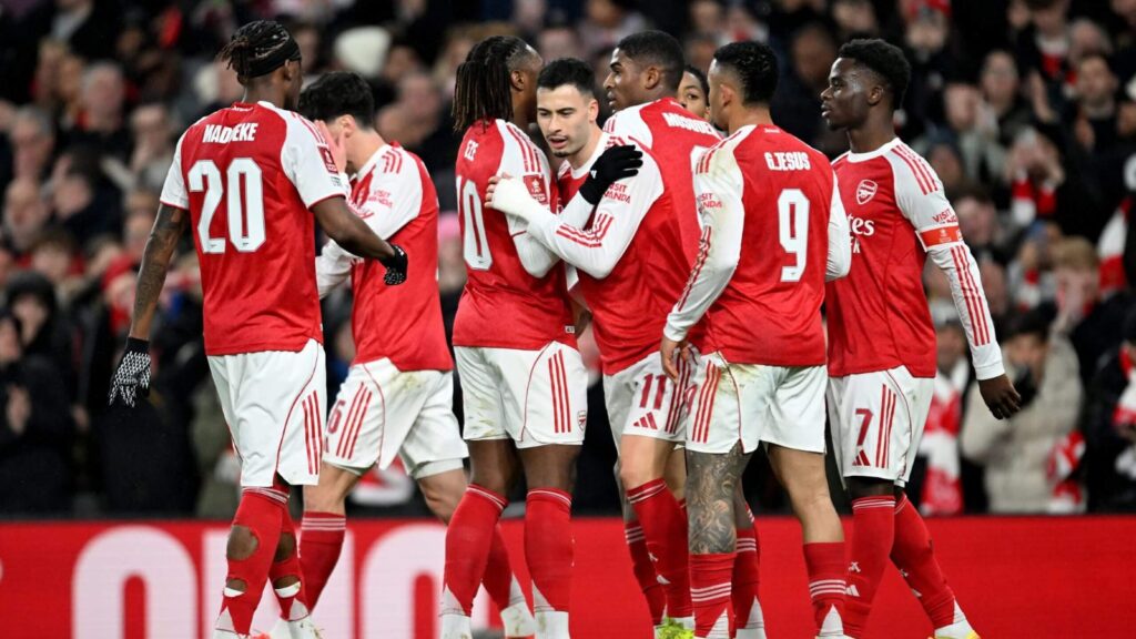 Arsenal FC believes winning the Premier League means more than lifting the Champions League trophy The Arsenal FC players celebrating a goal euphorically.