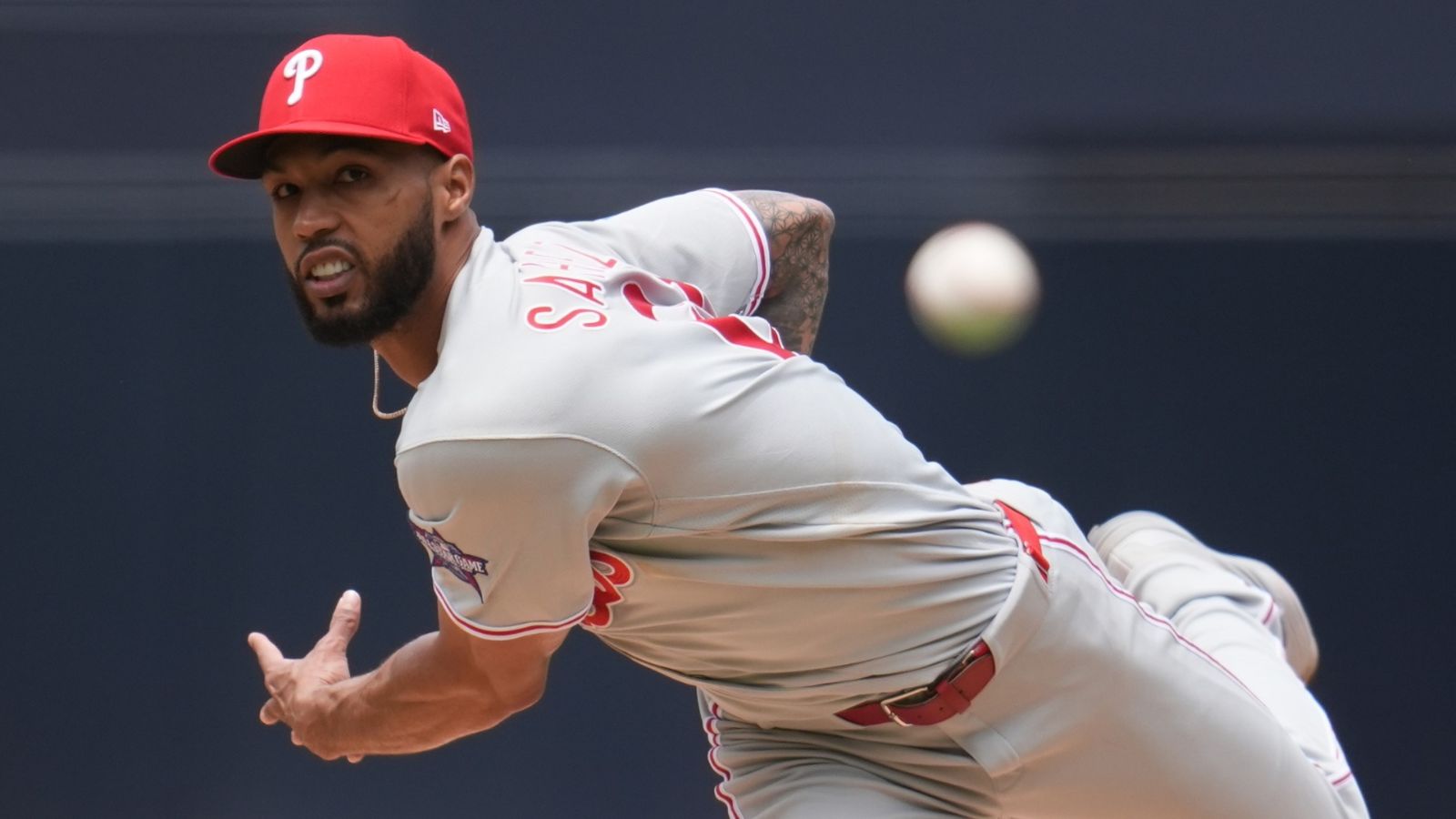 An image of the Dominican pitcher Cristopher Sánchez throwing a baseball in his pitching delivery stance.