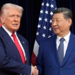 The top leaders of both world powers shaking hands while being photographed during a conversation.