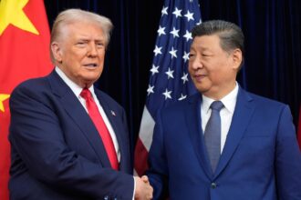 The top leaders of both world powers shaking hands while being photographed during a conversation.