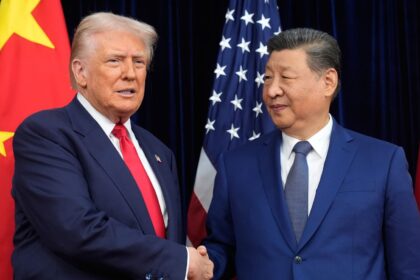 The top leaders of both world powers shaking hands while being photographed during a conversation.