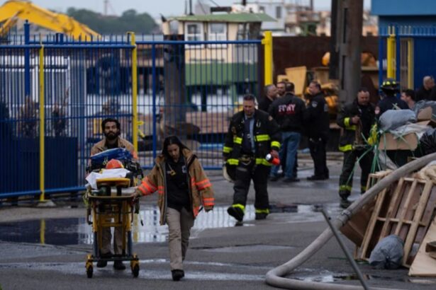 Firefighters and police officers helping injured people out on stretchers.