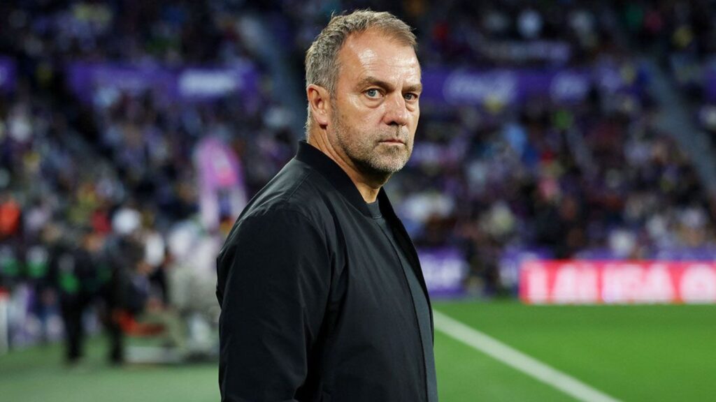 The German coach from the sidelines directing his 11 players on the field.