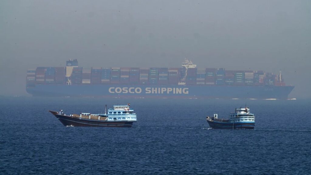 Two small Iranian boats stopping the advance of a massive ship trying to pass through the Strait of Hormuz.
