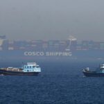 Two small Iranian boats stopping the advance of a massive ship trying to pass through the Strait of Hormuz.