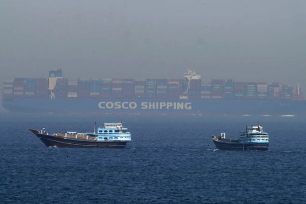 Two small Iranian boats stopping the advance of a massive ship trying to pass through the Strait of Hormuz.