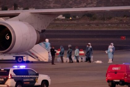 Several people wearing biohazard suits trying to board a plane linked to hantavirus.