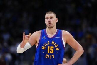 Nikola Jokic wearing his team’s blue uniform in the middle of an important game.